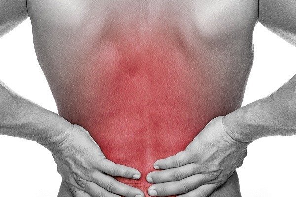 Man holding back due to back pain