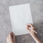 handwriting on white paper gray background for evidence submission