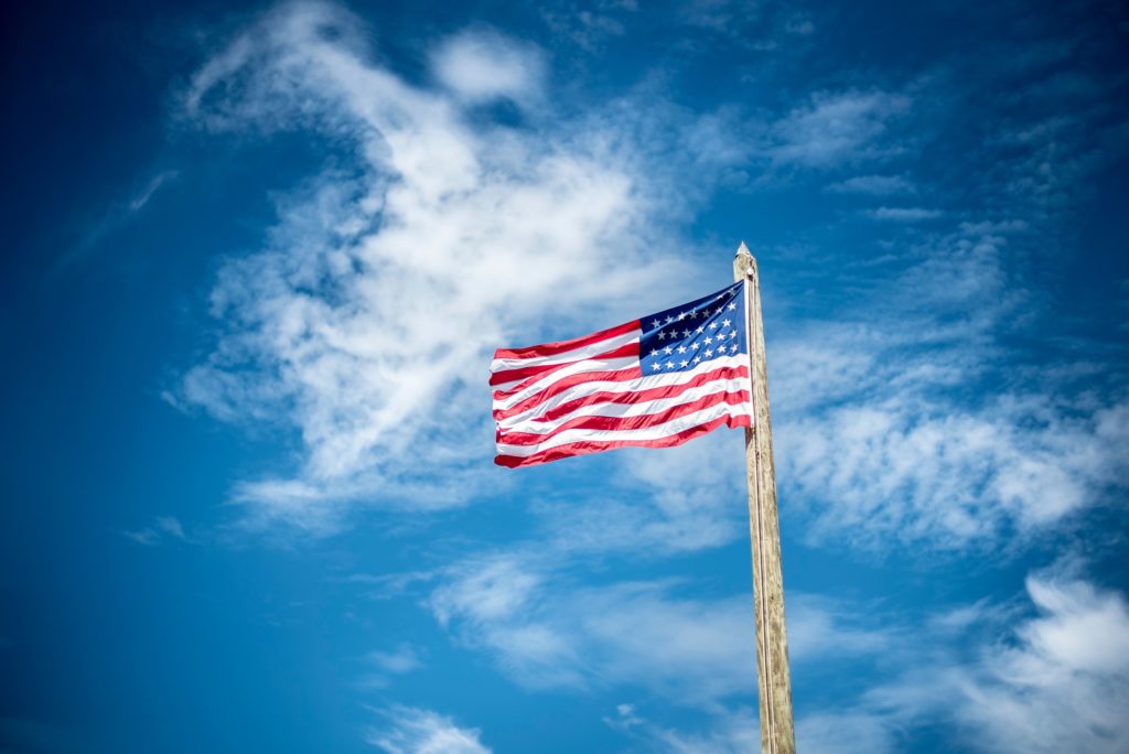 american flag on pole waving in wind