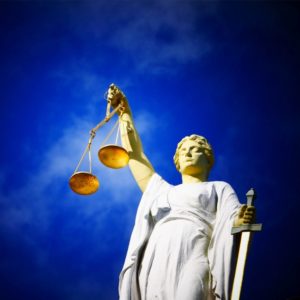 lady justice holding scales in front of blue sky court of appeals for veterans claims
