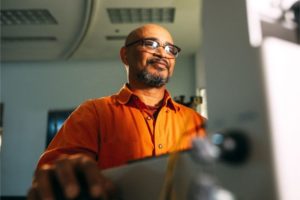 man applying for VA disability benefits on computer ebenefits
