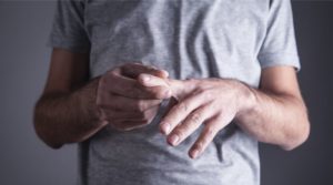 person with arthritis holding fingers
