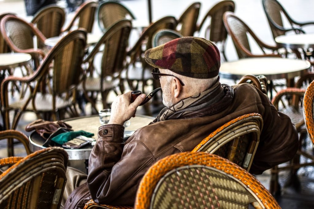man sitting and smoking a pipe