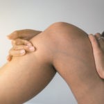 Person touching leg with visible veins due to Thrombophlebitis