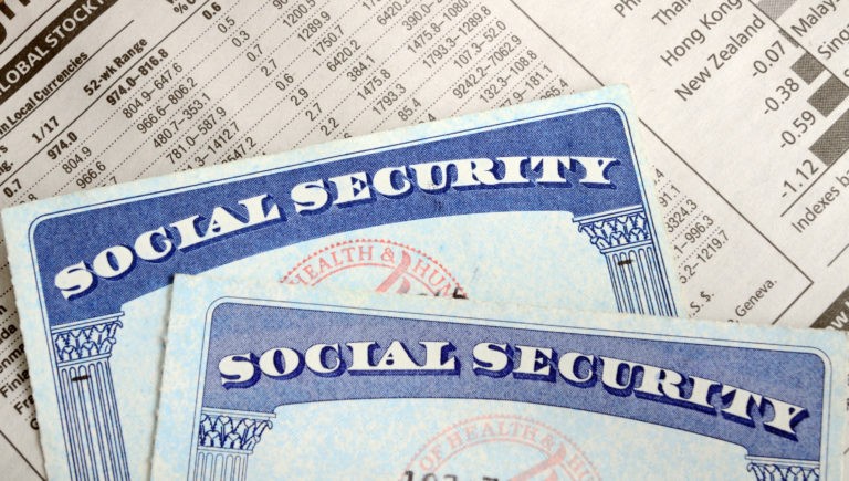 two social security cards on top of financial statement