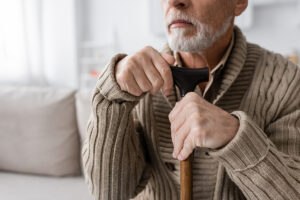 Man with cane suffering from Parkinson's disease wondering if it is a VA presumptive condition
