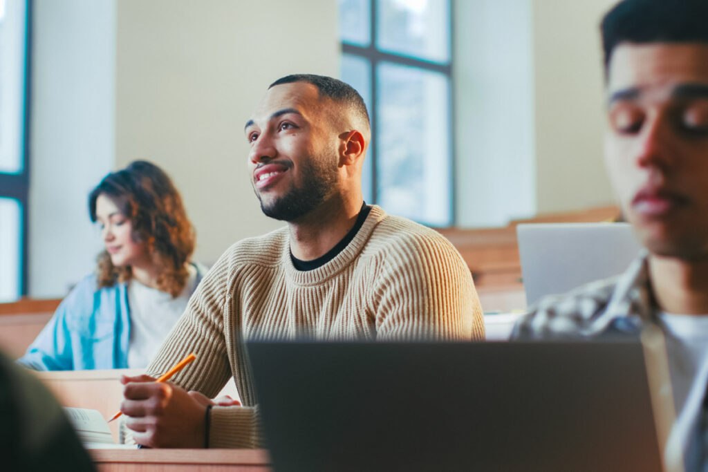 Man sitting in classroom at school.